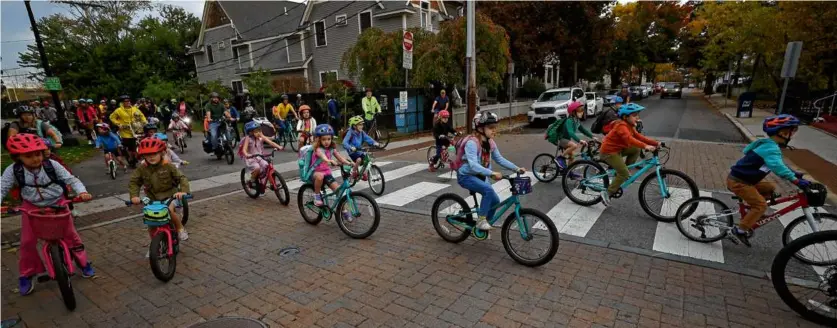  ?? DAVID L. RYAN/GLOBE STAFF ?? Parents and children at Peabody Elementary School rode in the bike bus on Oct. 27, 2023, in Cambridge.