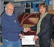  ??  ?? Cheque donation: Les Munckton, chairman of the Hampshire Narrow Gauge Railway Trust, presents a £2500 cheque to Valerie Mills, director of Amberley Museum, on February 5. The donation was in aid of the restoratio­n of 0-4-0ST Peter, which is behind the couple. AMBERLEY MUSEUM