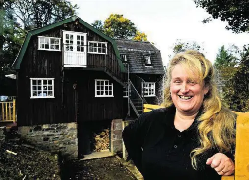  ??  ?? RURAL IDYLL: Owner Elaine Bunce at the working watermill and gift shop which lies off the A947 south of Banff