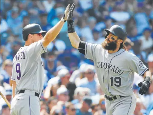  ?? Associated Press file ?? The Rockies’ Charlie Blackmon, right, and DJ Lemahieu have had a lot to celebrate this season, including a trip to the All-star Game.