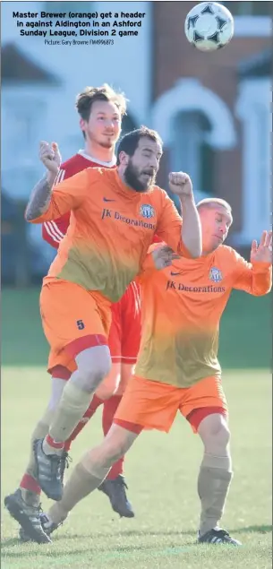  ?? Picture: Gary Browne FM4996873 ?? Master Brewer (orange) get a header in against Aldington in an Ashford Sunday League, Division 2 game