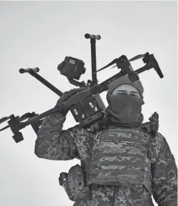  ?? LIBKOS/AP ?? A Ukrainian soldier carries a drone close to the front line Friday near Avdiivka in the Donetsk region of Ukraine.