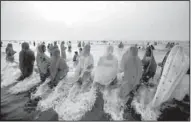  ?? AP/RAFIQ MAQBOOL ?? Indian Hindus perform rituals at sunset in the Arabian Sea during the Chhath Puha festival Friday in Mumbai. On Chhath, the rituals thank the sun god for sustaining life on earth.