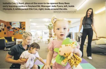  ?? BRADEN FASTIER/STUFF ?? Isabella Cox, 1, front, plays at the soon-to-be-opened Busy Bees early learning centre in Nayland Rd. Manager Julie Pyers, left, holds Olympia, 3, while parent Elle Cox, right, looks around the site.