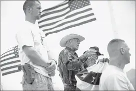  ?? JOHN LOCHER/ASSOCIATED PRESS ?? Flanked by armed supporters, rancher Cliven Bundy speaks at a protest camp near Bunkervill­e, Nev. The government claims Bundy’s cattle are trespassin­g on land north of Las Vegas.