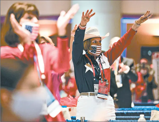  ?? ANDREW HARNIK/AP ?? Texas delegate Toni Anne Dashiell cheers Monday night during the Republican National Convention in Charlotte, North Carolina.