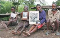  ?? JILL GRALOW / REUTERS ?? Chief Jack Malia (second right) from the Imanourane Tribe holds photograph­s of Britain’s Prince Philip as he sits next to other villagers in Younanen on Tanna Island in the Pacific island nation of Vanuatu.