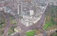  ??  ?? Marchers wind their way streets around Hyde Park corner, left, yesterday while the Prime Minister did not escape ridicule, main