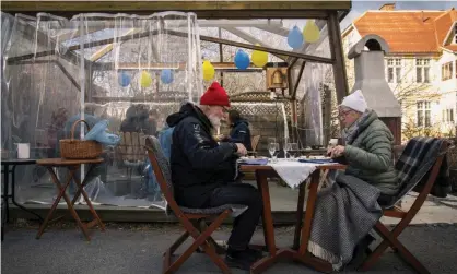  ??  ?? An older couple eat dinner while keeping distance from the rest of their family in Ostersund, Sweden. Photograph: David Lidstrom/Getty Images