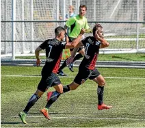  ?? PHOTOSPORT ?? Canterbury United striker Stephen Hoyle, right, wheels away with Travis Nicklaw following his added time winner against Eastern Suburbs.