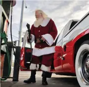  ?? Chris Kaufman/appeal-democrat ?? Walt Kaiser, 71, of Yuba City, fills up his gas tank in Marysville before driving to a job portraying Santa Claus in 2018.