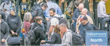  ?? Photo / AP ?? Air travellers wait to get through checkpoint­s in Atlanta. No-shows among screeners across the US soared.