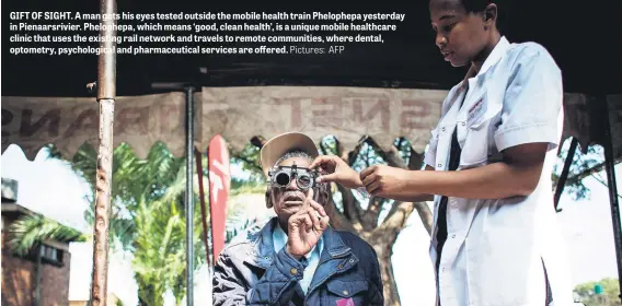  ?? Pictures: AFP ?? GIFT OF SIGHT. A man gets his eyes tested outside the mobile health train Phelophepa yesterday in Pienaarsri­vier. Phelophepa, which means ‘good, clean health’, is a unique mobile healthcare clinic that uses the existing rail network and travels to...