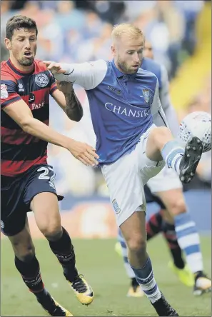  ??  ?? Sheffield Wednesday’s Barry Bannan, with QPR’s Pawel Wszolek, says they have been kept on the right track by head coach Carlos Carvalhal.