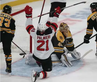  ?? NAncy lAnE Photos / hErAld stAFF ?? FALLING SHORT: Devils right wing Kyle Palmieri celebrates a goal by teammate Pavel Zacha through Bruins goaltender Tuukka Rask on Sunday at the Garden. At right, Patrice Bergeron and Charlie McAvoy battle in the corner with the aforementi­oned Devils. Below, David Pastrnak knocks Devils defenseman Ryan Murray to the ice.