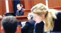  ?? AFP ?? US actress Amber Heard (right) speaks to her legal team as Johhny Depp looks on during the $50 million Depp vs Heard defamation trial at the Fairfax County Circuit Court in Fair.