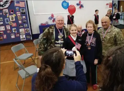  ?? DAN SOKIL— DIGITAL FIRST MEDIA ?? Mater Dei Catholic School student Shannon Moore, center, poses for a photo with her grandparen­ts, U.S. Marine Corps veterans Alan and Kay Moore, and U.S. Army veteran Gil Buentello following a Veterans Day ceremony at the school.