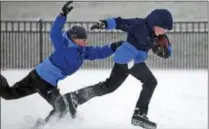  ?? AILEEN DEVLIN—THE DAILY PRESS VIA AP ?? Nathan Cochran, 10, attempts to grab Jackson Robbins, 10, as they play football in the snow on Thursday, Jan. 4, 2018, in Newport News, Va.