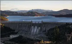  ?? KENT NISHIMURA/LOS ANGELES TIMES ?? Mount Shasta, seen as a backdrop to Upper Lake Shasta, at the Shasta Dam on Feb. 17 in Shasta County.