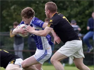  ??  ?? Cathal Devereux of Our Lady’s Island under pressure from Mark Cowman (Adamstown).