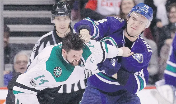  ?? — CP ?? The Stars’ Jamie Benn trades punches with the Canucks’ Nikita Tryamkin during a fight Thursday at Rogers Arena. Tryamkin stole the show, but Dallas won the game.