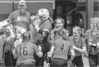  ?? Stephen Spillman /Contributo­r ?? Katy Janes rises above her Huffman Hargrave teammates as the center of the celebratio­n following her two-run homer against Anna in the Class 4A state title game Saturday in Austin.