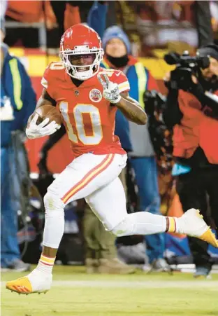  ?? COLIN E. BRALEY/AP ?? Then-Chiefs wide receiver Tyreek Hill heads toward the end zone to score on a 64-yard pass during the second half of a divisional-round playoff game against the Bills on Jan. 23 in Kansas City.