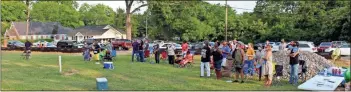  ?? Olivia Morley ?? The crowd listens to speakers at the Juneteenth celebratio­n at Greater Mount Calvary Baptist Church on Friday evening. Folks gathered on the lawn and also listened in their cars parked in the parking lot and along the road.