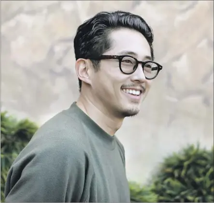  ?? Katie Falkenberg Los Angeles Times ?? “WALKING DEAD” star Steven Yeun plays a Gatsby type in the mystery-drama “Burning,” filmed in his birthplace of South Korea.