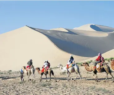  ?? /123RF ?? Echoes of the past: The Mingsha Shan Mountain on the edge of the Taklimakan desert, 6km south of Dunhuang. The sand that covers the mountain is said to make a musical sound when strong winds blow.