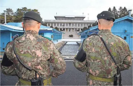  ?? EPA ?? South Korean soldiers stand guard during an inter-Korean meeting Tuesday at the border village of Panmunjom.