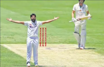  ?? AP ?? Shardul Thakur gets Pat Cummins out leg-before, his second wicket in as many overs, to restrict Australia at the Gabba.