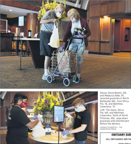  ??  ?? Above: David Benkin, 85, and Rebecca Adler, 81, received groceries in North Bethesda, Md., from Dhruv Pai, 16, and Matthew Casertano, 15.
Left: The teens, Dhruv Pai, left, and Matthew Casertano, 1both of North Potomac, Md., wipe down groceries with disinfecta­nt before the delivery.