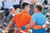  ?? REUTERS
Photo: ?? Novak Djokovic and Rafael Nadal embrace after their quarterfin­al match.