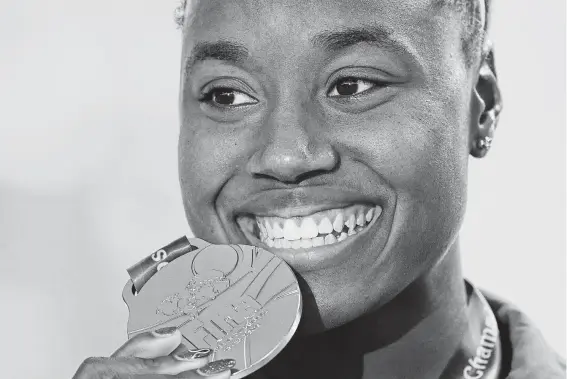  ?? Manan Vatsyayana / AFP/Getty Images ?? Simone Manuel became the first U.S. woman to win the 50 and 100 free at the world championsh­ips. Her seven medals are the most won by a woman at the event.