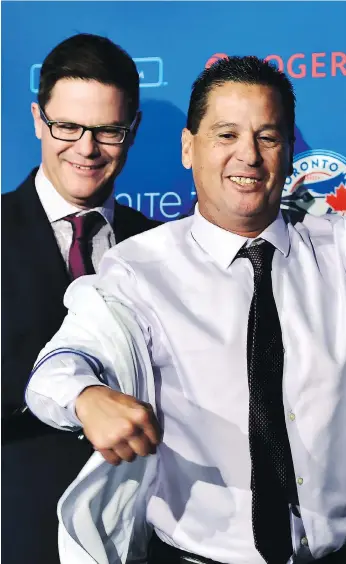  ?? FRANK GUNN/THE CANADIAN PRESS ?? Toronto Blue Jays GM Ross Atkins, left, officially introduces Charlie Montoyo as the team’s new manager Monday, with Montoyo looking comfortabl­e in his new pressure-packed position.