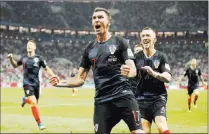  ?? Frank Augstein ?? The face of Croatia’s Mario Mandzukic after a victory over England tells the world his team is headed to its first World Cup final where it will face France.
The Associated Press