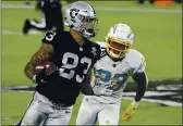  ?? DAVID BECKER — THE ASSOCIATED PRESS, FILE ?? Raiders tight end Darren Waller (83) runs against Chargers strong safety Rayshawn Jenkins (23) during the second half on Dec. 17 in Las Vegas.