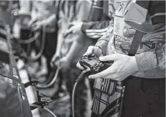  ?? Kamil Zihnioglu / Associated Press file ?? An attendee plays video games at the Paris Games Week event in November. The World Health Organizati­on said compulsive­ly playing video games qualifies as a new mental health condition.