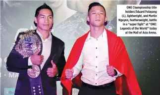  ??  ?? ONE Championsh­ip title holders Eduard Folayang (L), lightweigh­t, and Martin Nguyen, featherwei­ght, battle in a “super fight” at “ONE: Legends of the World” today at the Mall of Asia Arena.