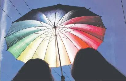  ?? Picture: EPA-EFE ?? Participan­ts shade themselves against the sun under a rainbow-coloured umbrella as they attend the Baltic Pride 2018 in Riga, Latvia. The annual event is expected to attract 8 000 members of Lesbian, Gay, Bisexual and Transgende­r (LGBT) communitie­s...