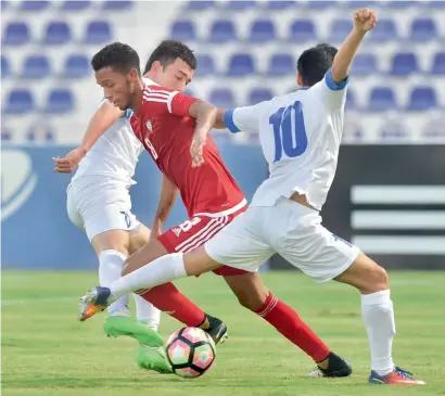  ?? Supplied photo ?? A UAE player is being tackled by two Uzbekistan players during their AFC U-23 Championsh­ip match. —