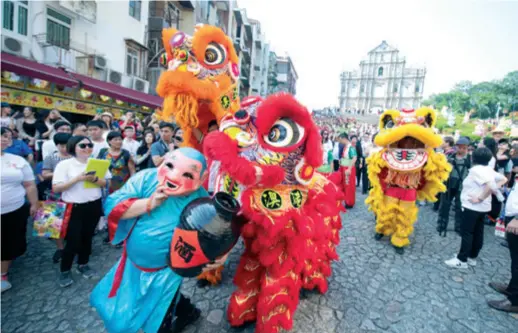  ??  ?? A lion dance is held in front of the iconic Ruins of the St. Paul’s in Macao, a 17th-century Catholic complex, in celebratio­n of World Tourism Day on September 27, 2019