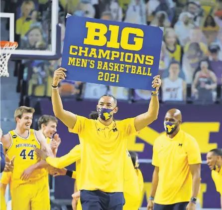  ?? RICK OSENTOSKI/ USA TODAY SPORTS ?? Juwan Howard celebrates winning the Big Ten regular- season championsh­ip, the third for his alma mater since 1987.