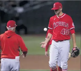  ?? PHOTOS BY JED JACOBSOHN — THE ASSOCIATED PRESS ?? Angels pitcher Steve Cishek, right, is taken out of the game by manager Joe Maddon during the sixth inning against the Oakland Athletics on Tuesday.