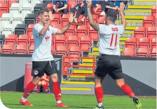  ??  ?? Clyde’s Mark Lamont is congratula­ted by team-mate Alistair Love (right) after scoring against Falkirk