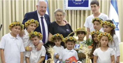  ?? (Mark Neyman/GPO) ?? PRESIDENT REUVEN RIVLIN and his wife, Nechama, welcome the children of dairy farmers at the President’s Residence in Jerusalem yesterday.