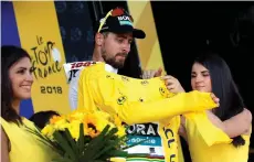  ?? Picture: REUTERS ?? I REMEMBER THIS FEELING: Peter Sagan of Slovakia celebrates on the podium, wearing the overall leader’s yellow jersey.