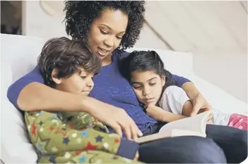  ??  ?? Mum reading to children.