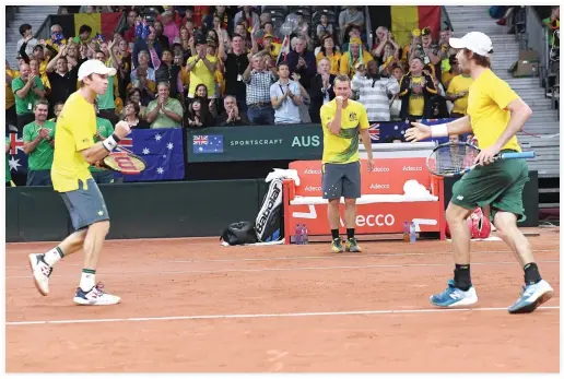  ??  ?? Australia’s captain Lleyton Hewitt, center, and players Jordan Thompson, right, and John Peers celebrate after winning the Davis Cup semi final between Belgium and Australia in Brussels on Saturday. (AFP)